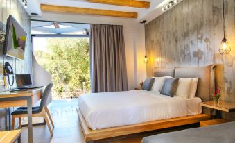 a modern bedroom with a large bed , wooden furniture , and a window overlooking a garden at Royal Hotel and Suites