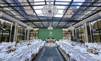 a large , open room with a chandelier and tables set up for an event , likely a wedding or conference at The Chateau Spa & Wellness Resort