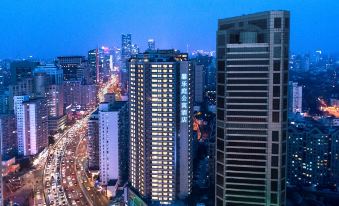 A city at night with tall buildings and skyscrapers in the background at Citadines Apart Hotel (Shanghai Yan'an West Road)