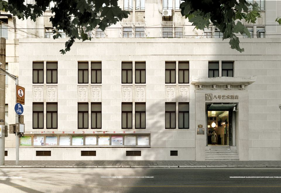 There is a large building with many windows located next to an empty street at Yuzhan No.8 Art Hotel (Shanghai Beach Branch)