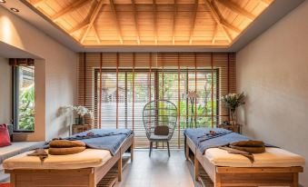 a spa room with two massage tables , one on the left and one on the right at Grand Mercure Khao Lak Bangsak