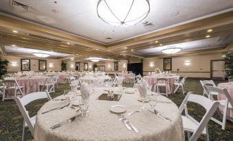 a large banquet hall with tables and chairs set up for a formal event , possibly a wedding reception at Grand Vista Hotel