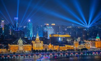 The illuminated city skyline and waterfront create a captivating nighttime scene at Pudong Shangri-La, Shanghai