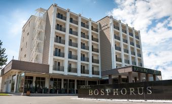 "a large hotel building with a sign that reads "" bosphorus hotel "" prominently displayed on the front" at Bosphorus Hotel
