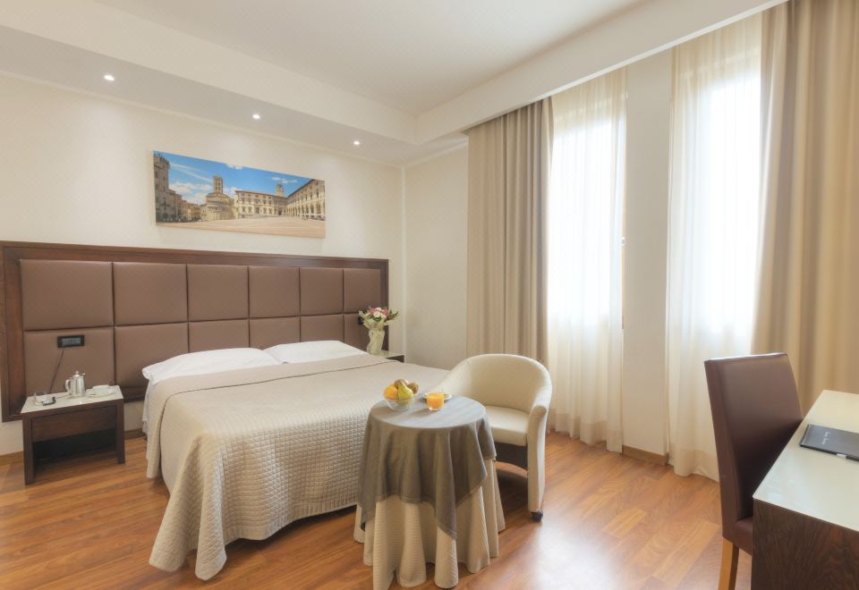 a modern hotel room with wooden floors , white walls , and a bed with a gold headboard at Hotel Minerva