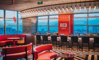 restaurant with ample natural light and centrally located tables at Radisson RED Hotel Zhuhai Gongbei Port