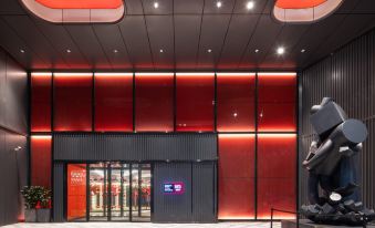 The lobby is illuminated by large, bright lights and a series on each side at Radisson RED Hotel Zhuhai Gongbei Port