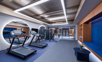 The room is spacious and contains multiple exercise equipment, as well as an indoor gym area at Crystal Orange Shenzhen Nanshan Science and Technology Park Hotel