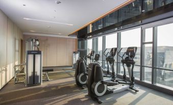 The hotel features a spacious gym with large windows and an indoor exercise area in the middle at Hyatt Place Shanghai Hongqiao CBD