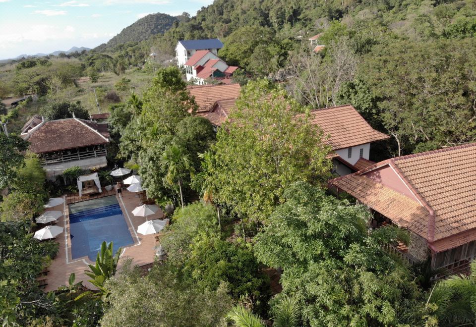 a bird 's eye view of a resort nestled in the mountains with a pool and red - tiled roofs at Tara Lodge Haven of Peace