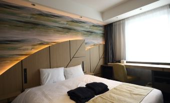 a hotel room with a large bed , a chair , and a painting on the wall at Hotel Torifito Hakata Gion