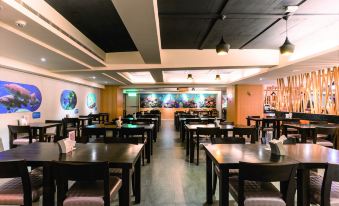 a large dining room with multiple tables and chairs arranged for a group of people at Fish Hotel -Taitung