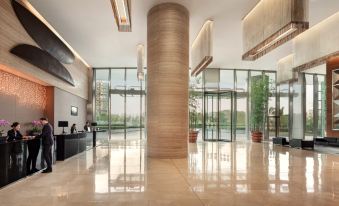 The building has a lobby and entrance with large windows on both sides, which lead into another area at Novotel Citygate Hong Kong