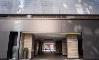 The entrance to a building has an open doorway that leads into another room in front at Empire Hotel Hong Kong－Wan Chai