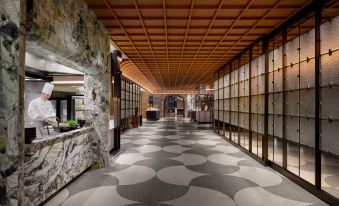 In this modern home, there is a long hallway with tiled floors and a tiled ceiling in the main room at Shanghai Marriott Marquis City Centre