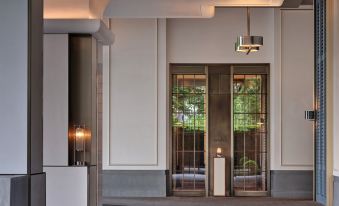 The entrance to a building features large windows and doors on both sides, providing access to another area at Andaz Shenzhen Bay