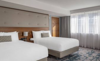 a hotel room with two beds , one on the left and one on the right side of the room at Vienna Marriott Hotel