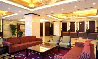The hotel has a spacious lobby or reception area with comfortable seating options such as couches and chairs at Sunworld Hotel