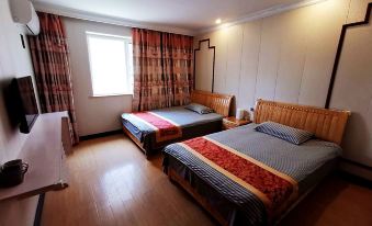 One bedroom has two beds, while the other has an open window at Shengsi wolfberry island on the island to the fisherman's family
