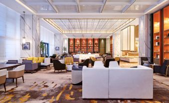 The hotel offers a spacious room with tables and chairs in the center, as well as a bar counter and stools, providing a comfortable space for guests to unwind and socialize at LEFUQIANG BOYUE HOTEL