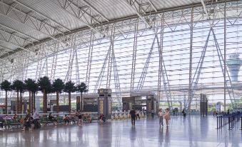 The interior of Terminal 1 is a spacious airport with numerous windows and ample air circulation at Hanqun Hotel (Guangzhou Baiyun International Airport)