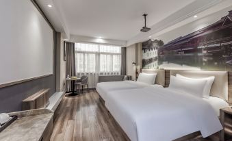 The modern bedroom features a double bed and a large window that overlooks the rest area at Jinhao International Hotel