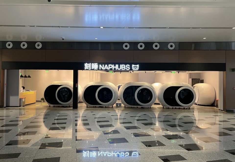 The new logo is prominently showcased on a white tiled floor in a spacious airport terminal at Ke Sleeping Lounge (Beijing Daxing Airport Terminal)