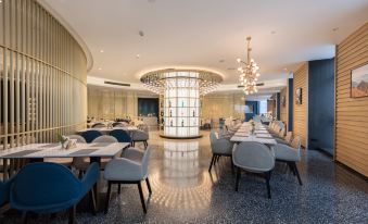 The restaurant features a central area with tables and chairs, as well as an open concept dining room at Atour S Hotel Zhongbei Road  Chuhe Han Street