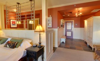 a hotel room with a bed , nightstand , and lamps , as well as an entrance to the lobby at Hilton Grand Vacations Club Blue Mountain Canada