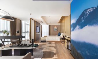 A spacious room with a bed and balcony is available in an apartment or hotel suite at Atour S Hotel Zhongbei Road  Chuhe Han Street