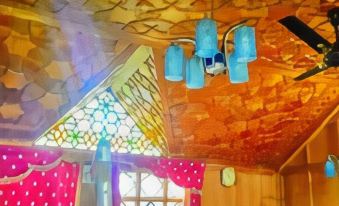 a room with a wooden ceiling and walls , featuring blue lanterns hanging from the ceiling at Dawn