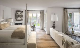 a modern living room with white furniture , including a couch , chairs , and a coffee table at Farmhouse Inn