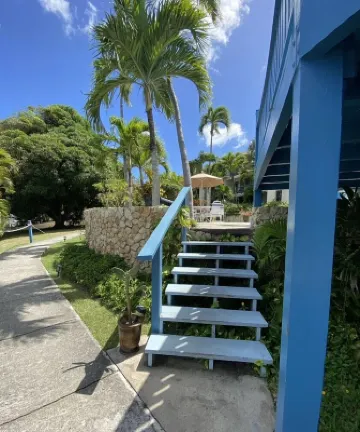 Tropical one bedroom condo steps from pool.