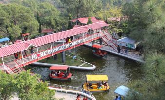 Visitors can enjoy boat rides in the water at a popular theme park or amusement center, along with numerous other tourists at Bombay Picnic Spot Hotel & Resort