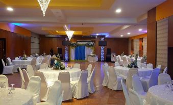 a large banquet hall with round tables and chairs set up for a formal event at Hotel La Hacienda