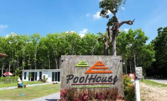 "a large sign for "" pool house "" in front of a building , surrounded by trees and grass" at Pool House Lanska