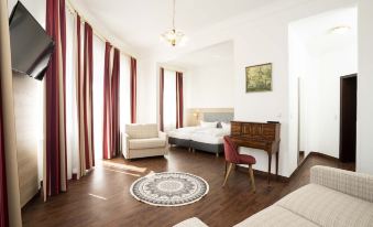 a modern living room with wooden floors , white walls , and large windows , featuring a couch , dining table , and piano at Hotel National