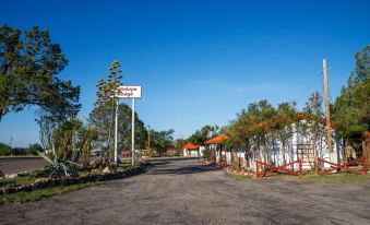 "a deserted road with a sign that says "" kakukuu park "" and an orange building in the background" at Antelope Lodge