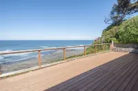 Dramatic oceanfront views. Open high ceilings. Huge deck & walls of windows!