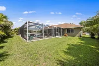 Tropical Oasis sleeps 13 with a heated pool.  Free WiFi.  Close to everything