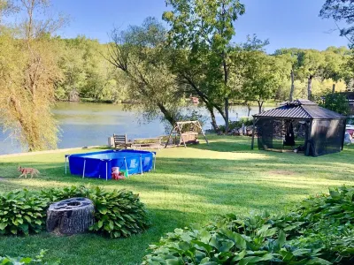 Your Dream Getaway 220’ Waterfront Beach House Rock River WI FP Pool Pier Kayaks