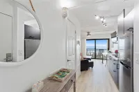 Balcony Suite with Leather Sofa and Kitchen Amenities - Charming Coastal Retreat Hotel a Crescent Beach