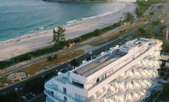 aerial view of a white building near the beach , with the ocean in the background at CDesign Hotel