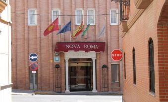 "a red brick building with the name "" novagna roma "" on it , surrounded by flags and a stop sign" at Nova Roma