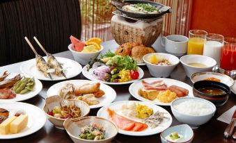 a table is filled with various dishes , including salads and meats , in a variety of bowls and plates at Hotel Resol Gifu