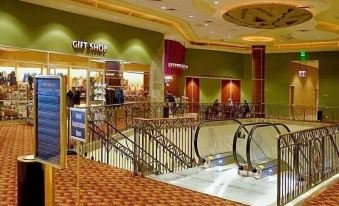 a large shopping mall with a carpeted floor and several escalators leading to the entrance at Gold Country Casino Resort