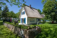 Picturesquely situated thatched-roof house in a large park-like garden