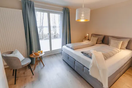 Vacation apartment between forest and lake with two terraces