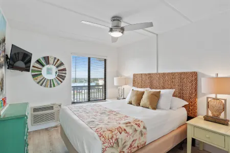 Balcony Suite with Leather Sofa and Kitchen Amenities - Charming Coastal Retreat