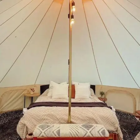 A luxurious glamping tent nestled in the trees.